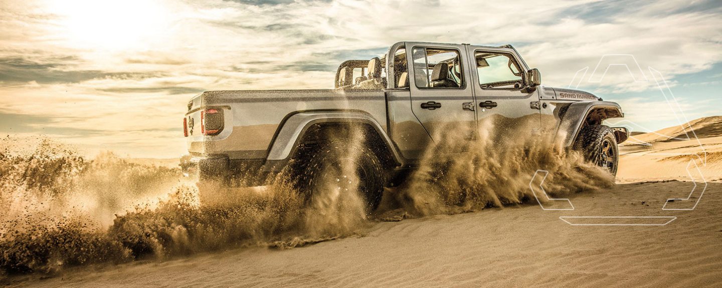 Mojave. A 2022 Jeep Gladiator Mojave being driven on sand in the desert, with the 4x4 Desert Rated logo superimposed overhead.