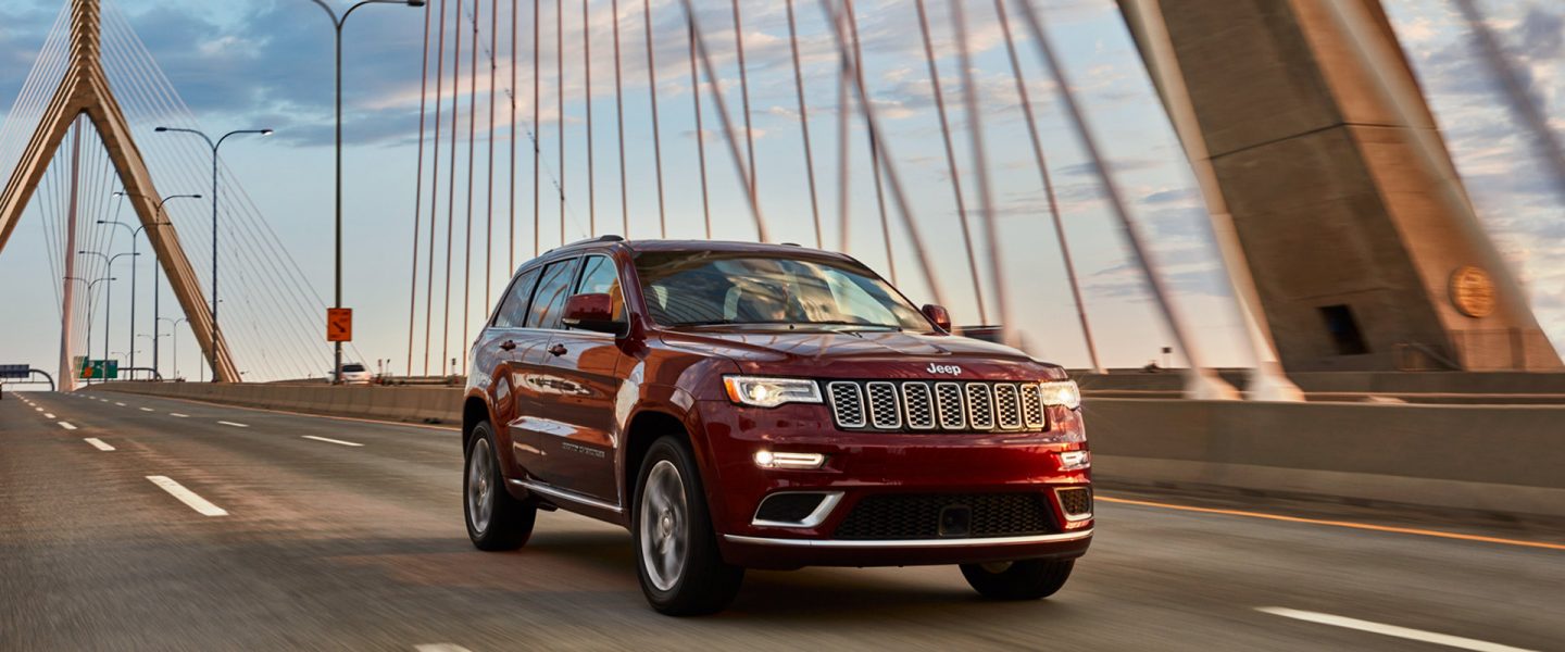 The 2020 Jeep Grand Cherokee being driven over a bridge.
