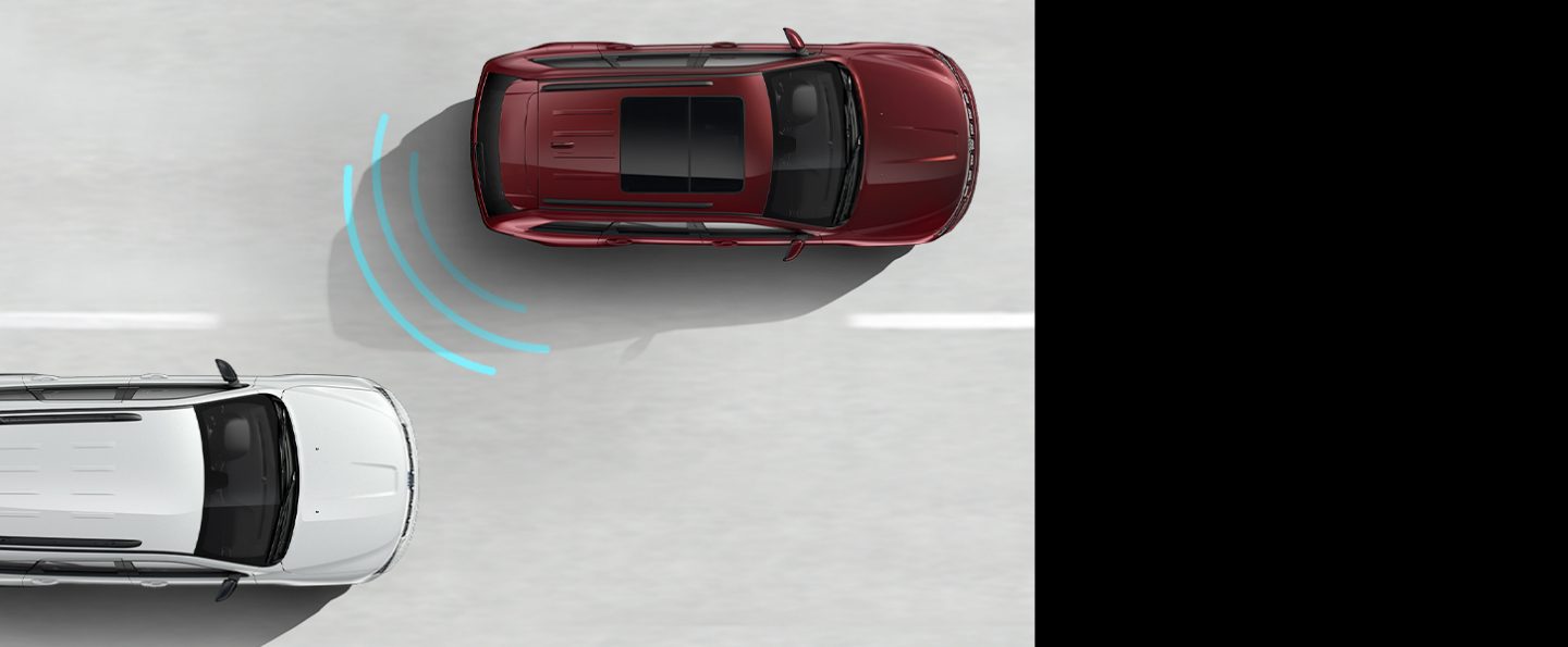 An illustration of the sensors in the rear of the 2020 Jeep Grand Cherokee detecting a vehicle approaching its blind spot.