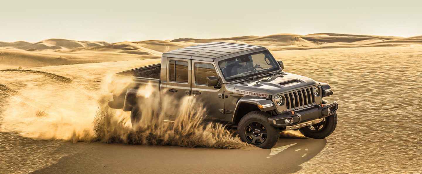 The 2021 Jeep Gladiator Sand  Runner being driven on sand.