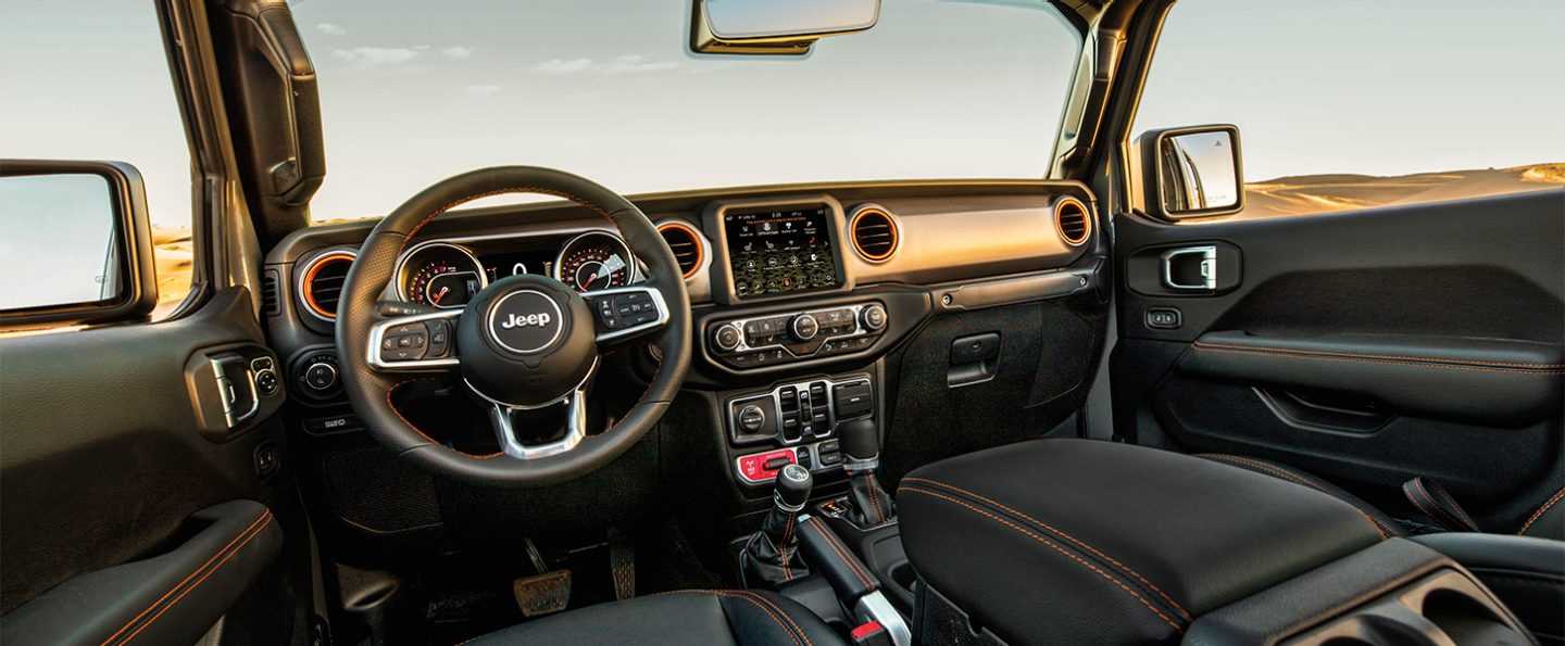 Interior view of the steering wheel, instrumentation center stack of glovebox in the 2020 Jeep Gladiator Mojave.