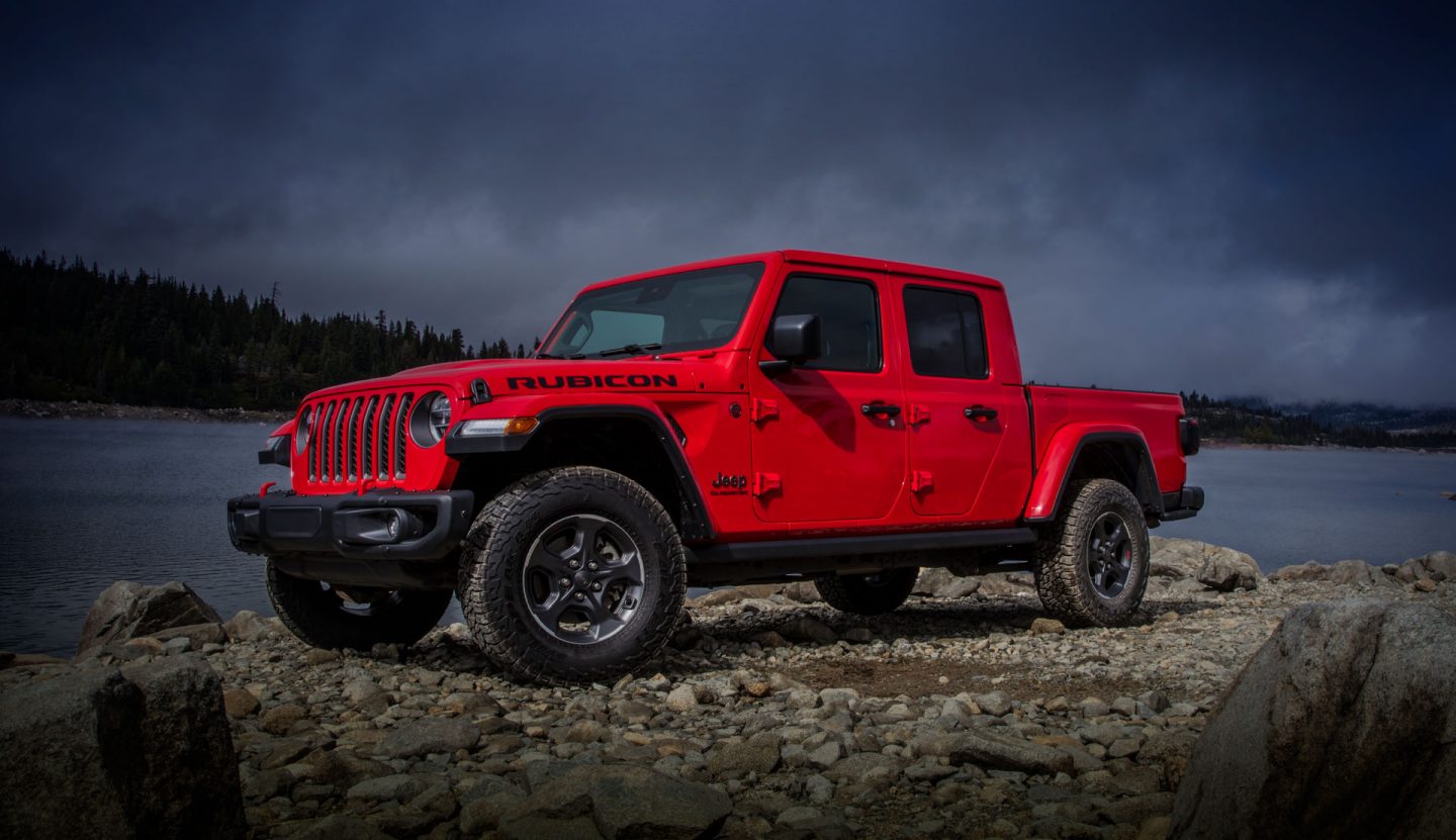 Rubicon. The 2022 Jeep Gladiator Rubicon parked on a rocky shore beside a lake.